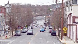 Road with cars moving in front of Hofford Mill