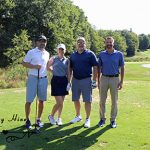 Three male golfers and one female golfer