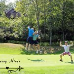Two male golfers body bumping and one male golfer making body builder pose
