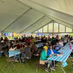 oktoberfest 22 people eating under tent