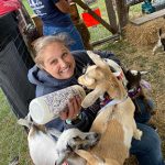 oktoberfest22 woman feeding goats with bottle