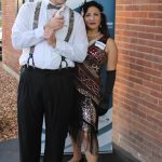 Man with white shirt and overalls and cap with flapper woman