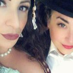 Showgirl and woman with top hat close up