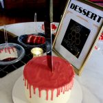 Red icing cake with knife in middle