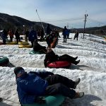 People tubing on ski slope