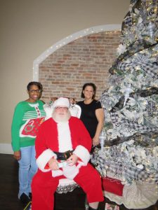 Owners of Party on Main pose with Santa