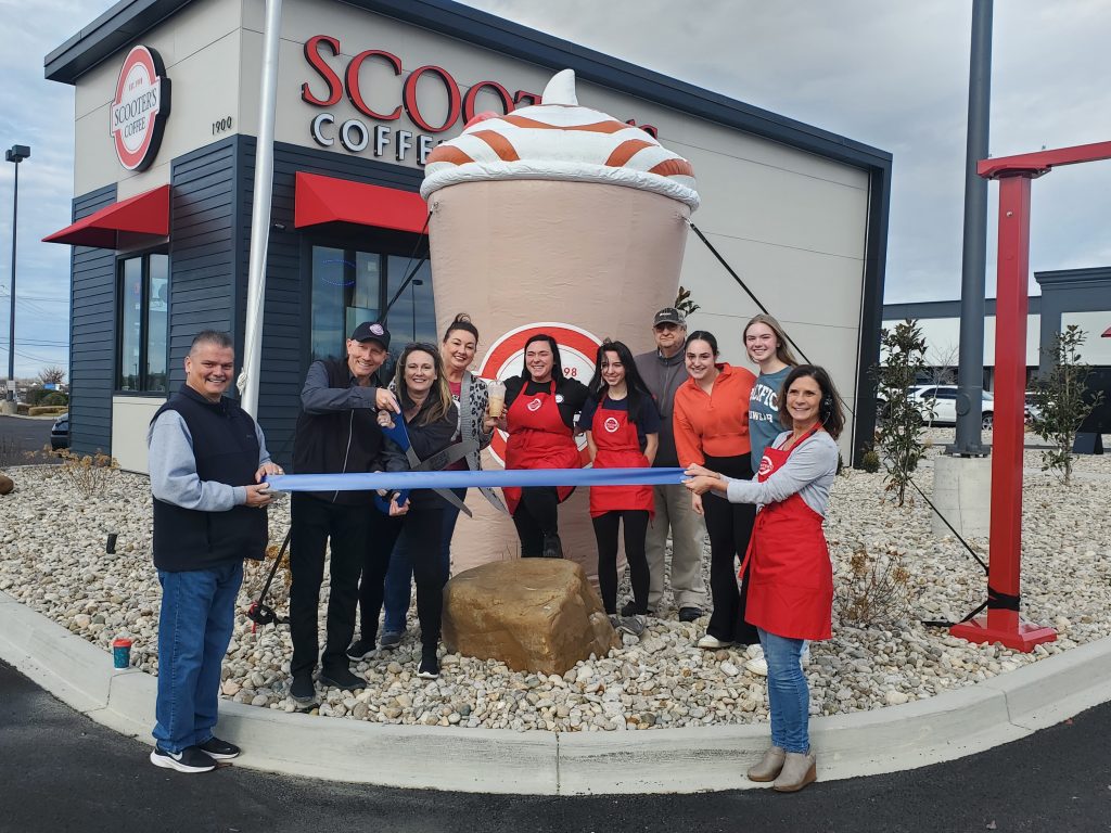 Brad and Michelle Piening cut the ribbon celebrating SCOOTER'S COFFEE