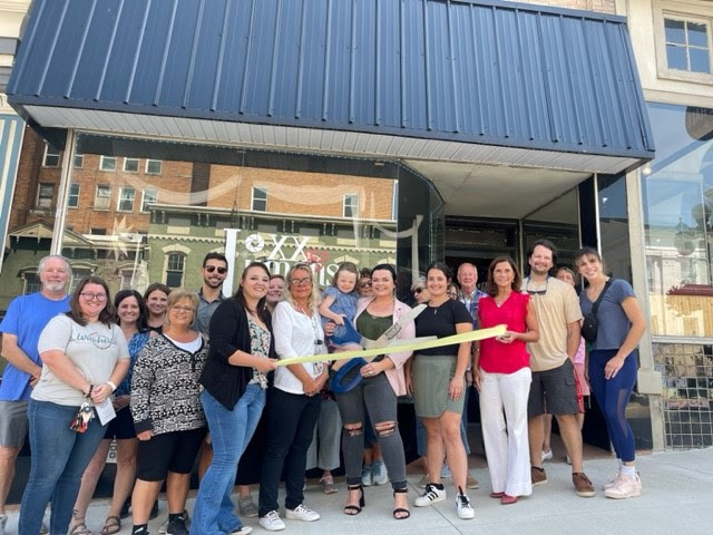 Betty Morris cuts the ribbon celebrating Loxx and Lumens Studios’ membership into the Winchester-Clark County Chamber of Commerce.