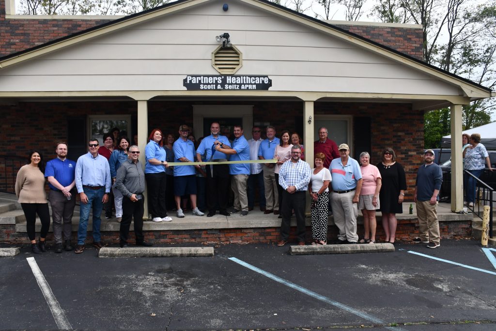 Scott Seitz cuts the ribbon celebrating Partners Healthcare membership into the Winchester-Clark County Chamber of Commerce.