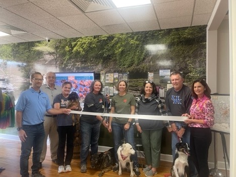 Brenda Siebold cuts the ribbon celebrating Devil Dog K-9 Fitness and Training, LLC membership into the Winchester-Clark County Chamber of Commerce.