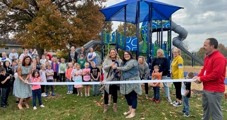 Diana Jackson, Principal, and Lindsey Campbell, Assistant Principal, of Shearer Elementary School cut the ribbon celebrating not only membership into the Winchester-Clark County Chamber of Commerce but a NEW playground!