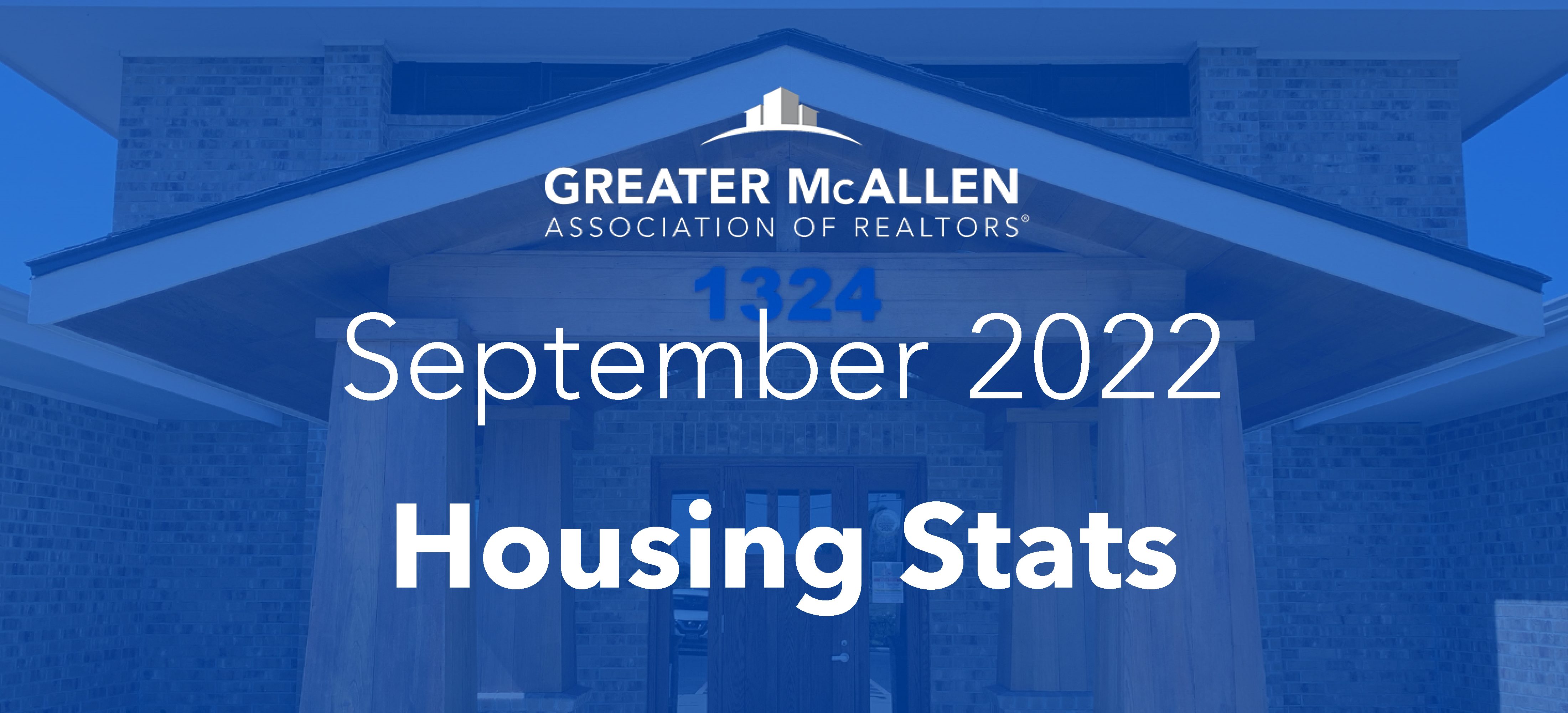 Blue graphic reading September 2022 Housing Stats in bold white letters over a photo of a brick building