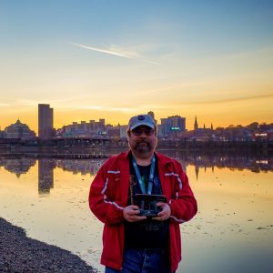 Craig Weston of Sky Photos LLC with Albany skyline at sunset in background