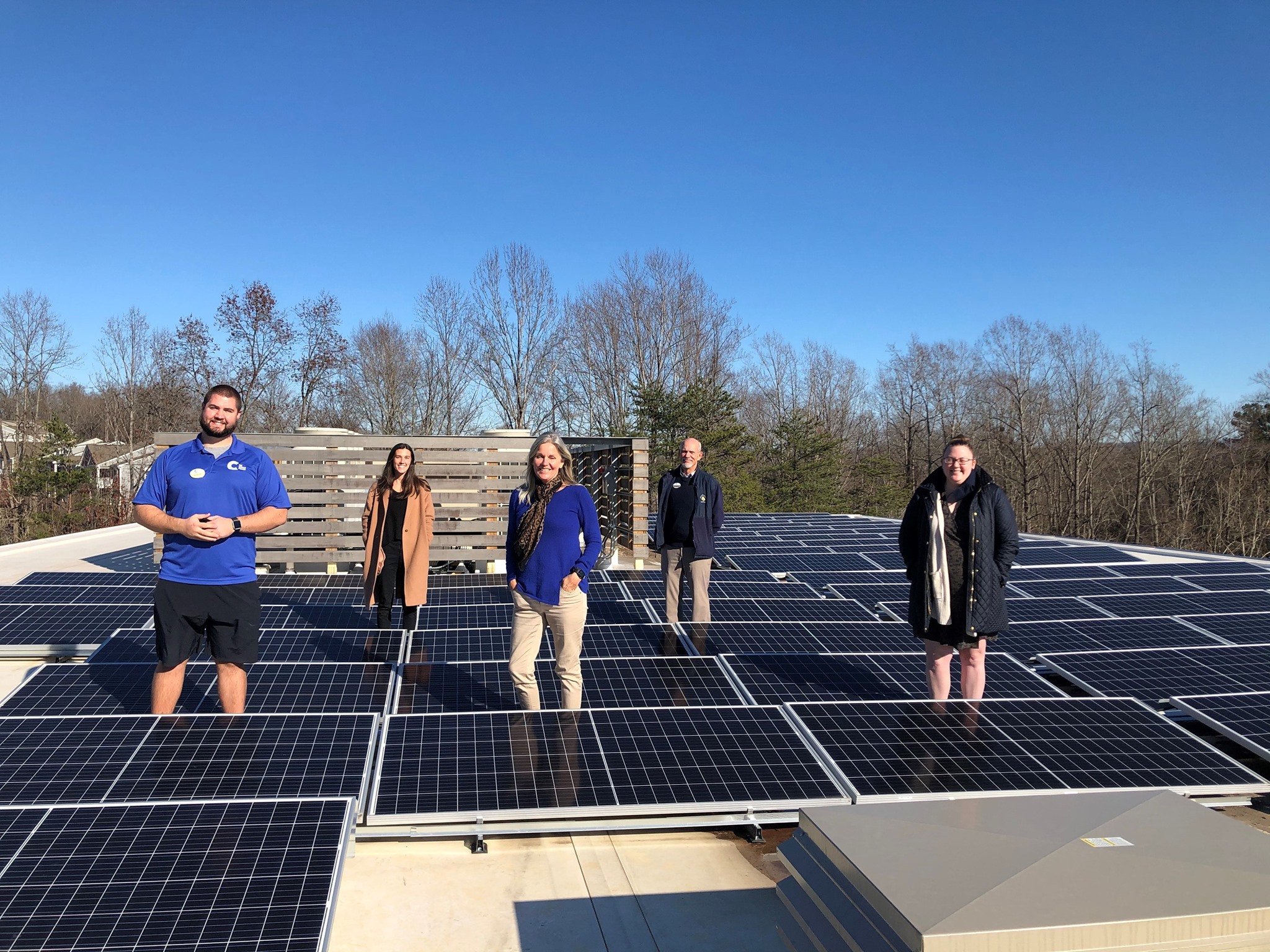 Staff of The Center at Belvedere show off their rooftop solar array.