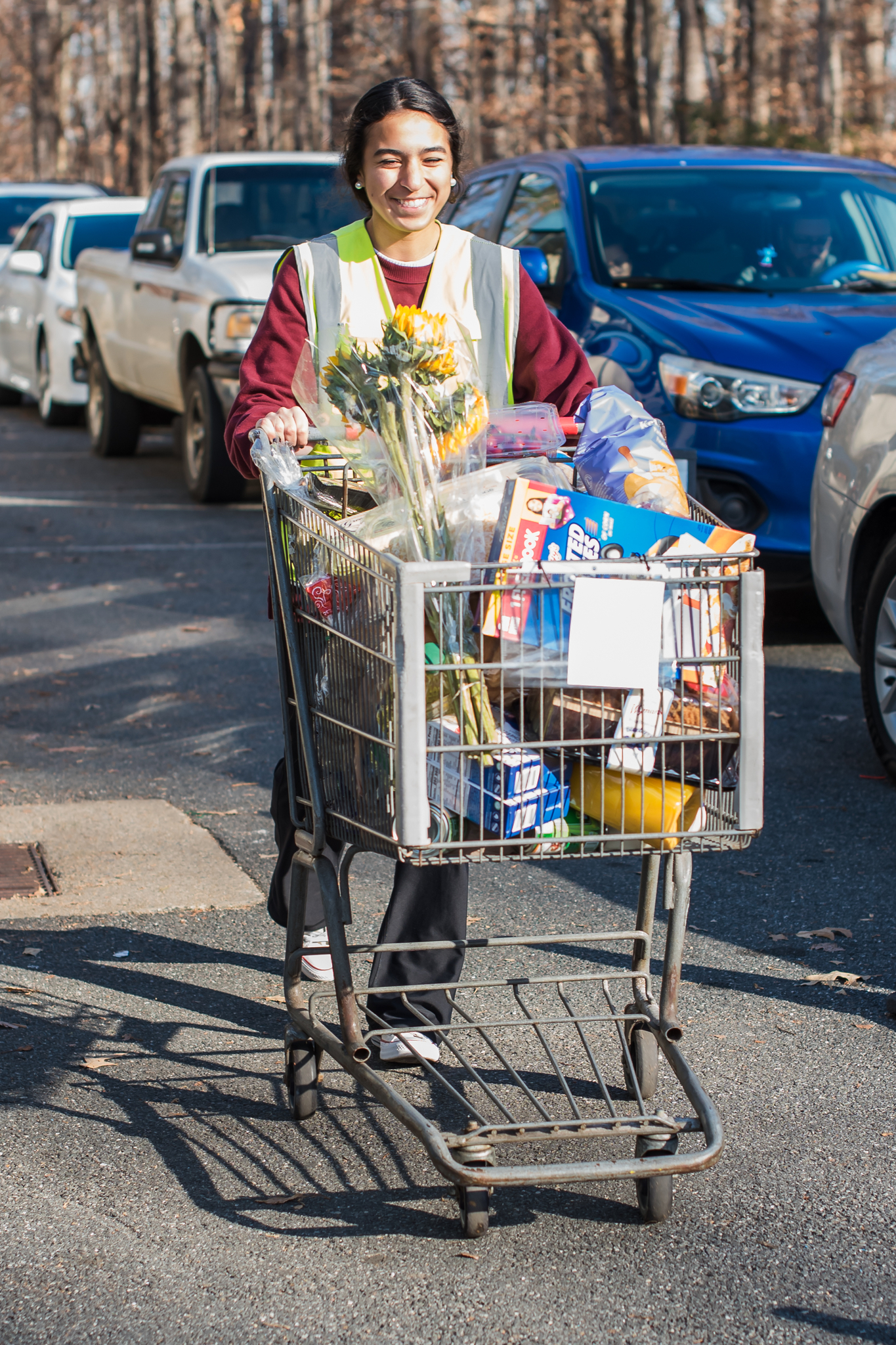 A volunteer helps distribute groceries at Loaves &amp; Fishes