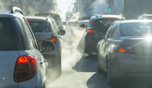 pollution from the exhaust of cars in the city in the winter. Smoke from cars on a cold winter day pollution from the exhaust of cars in the city in the winter. Smoke from cars on a cold winter day