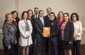 Student Honoree Christopher Ibarra (4th from right) with First Bank of Highland Park President and COO, Eric Ephraim (center) and bank representatives