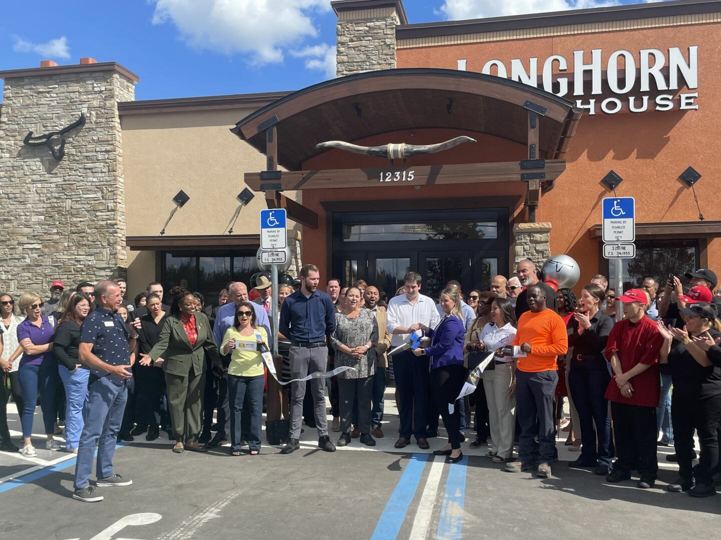 Katrina Marshall, Managing Partner, Longhorn Steakhouse, cuts ribbon for their grand opening, Tuesday, Oct 25.