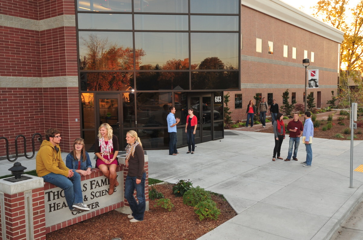Picture of students standing outside one of the buildings at the college.
