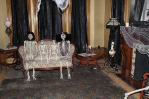 skeleton decorations sitting on a couch inside the remington museum