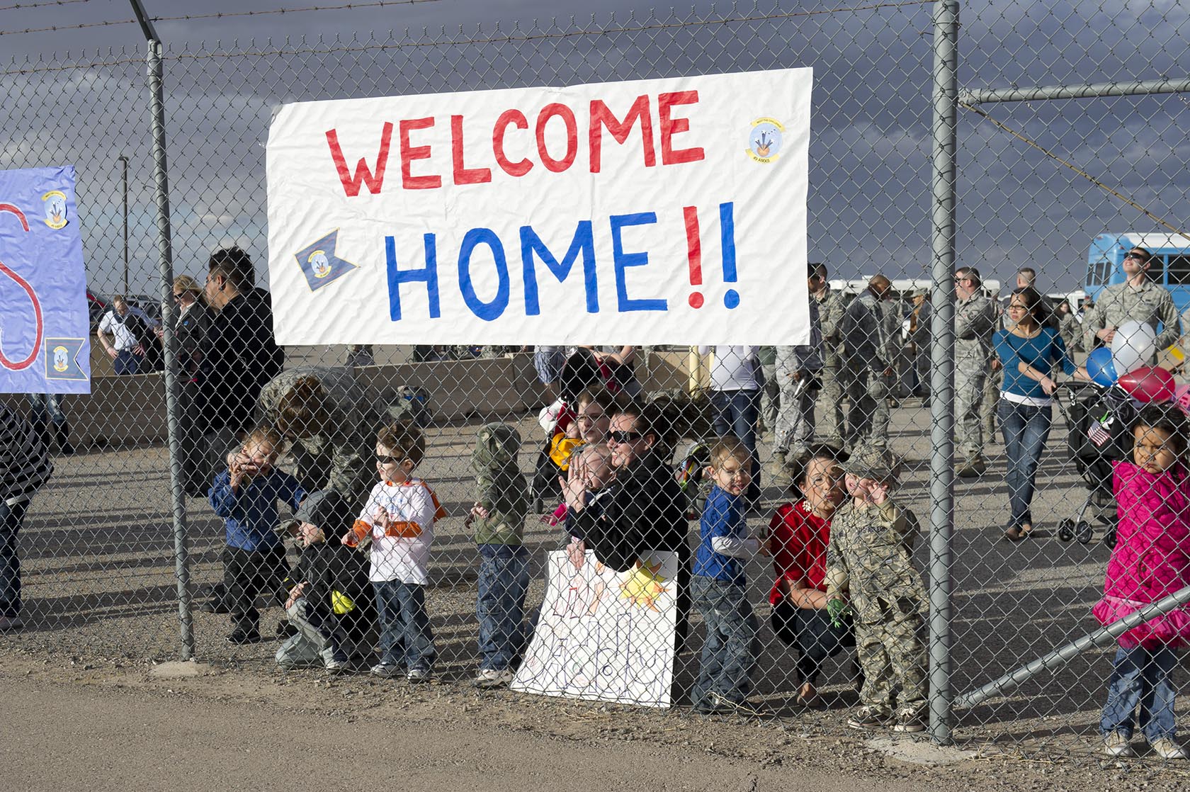 Friends and family await the return of around 200 airmen from the 7th Fighter Squadron and the 49th Maintenance Group on the Holloman Air Force Base, N.M. flightline, Jan. 28. F-22 Raptors and around 200 personnel returned Monday from a nine-month deployment to Southwest Asia ensuring regional security and joint tactical air operations. (U.S. Air Force photo by Airman 1st Class Michael Shoemaker/Released)