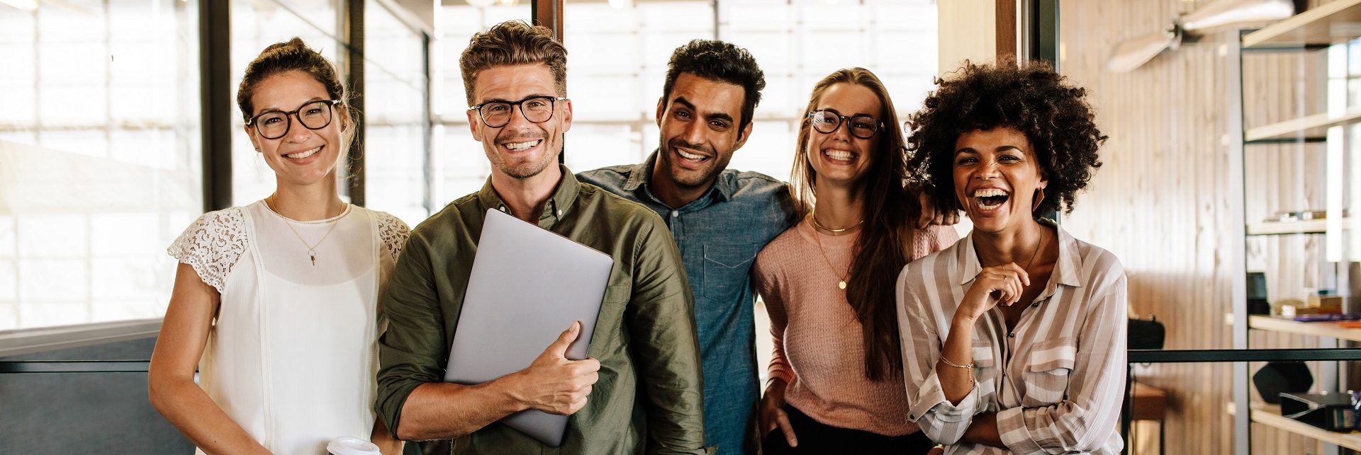 SWPP Portrait of creative business team standing together and laughing. Multiracial business people together at startup.