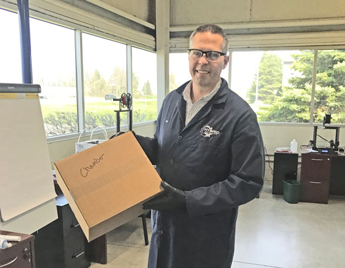 Jeff Robinson with box of face shields for PPE