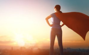 Woman superhero in power pose for Women Inspiring Women article