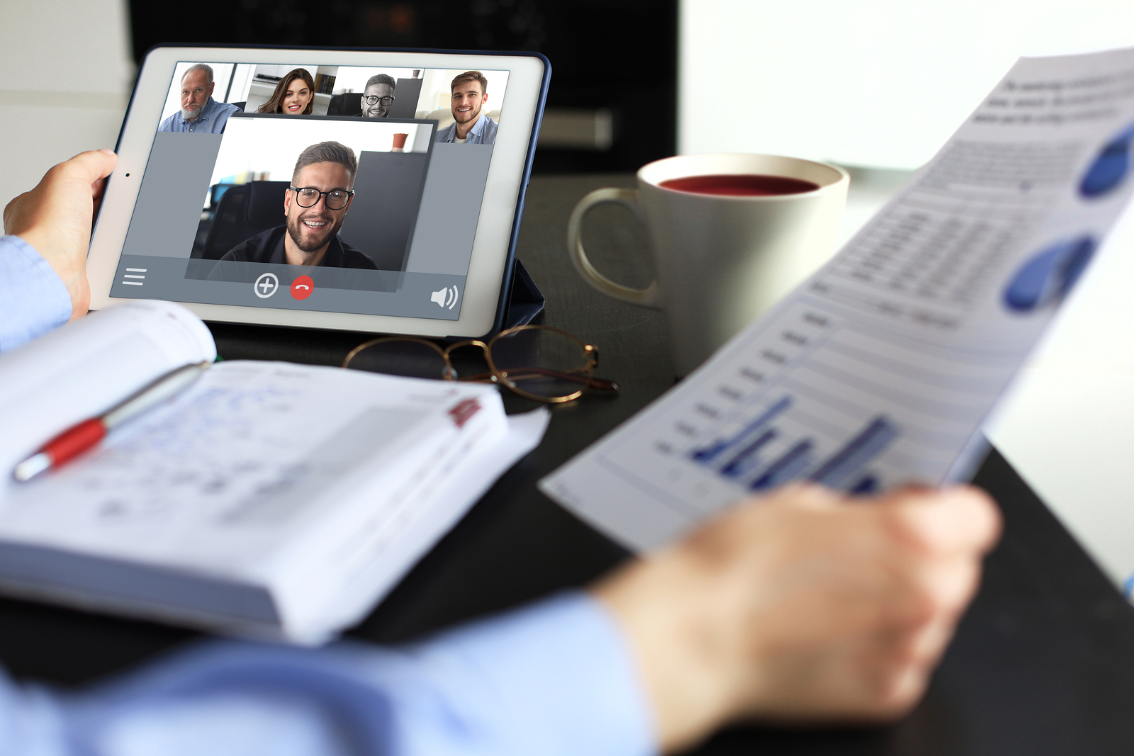 Networking Business woman talking to her colleagues in video conference. Business team working from home using digital tablet.