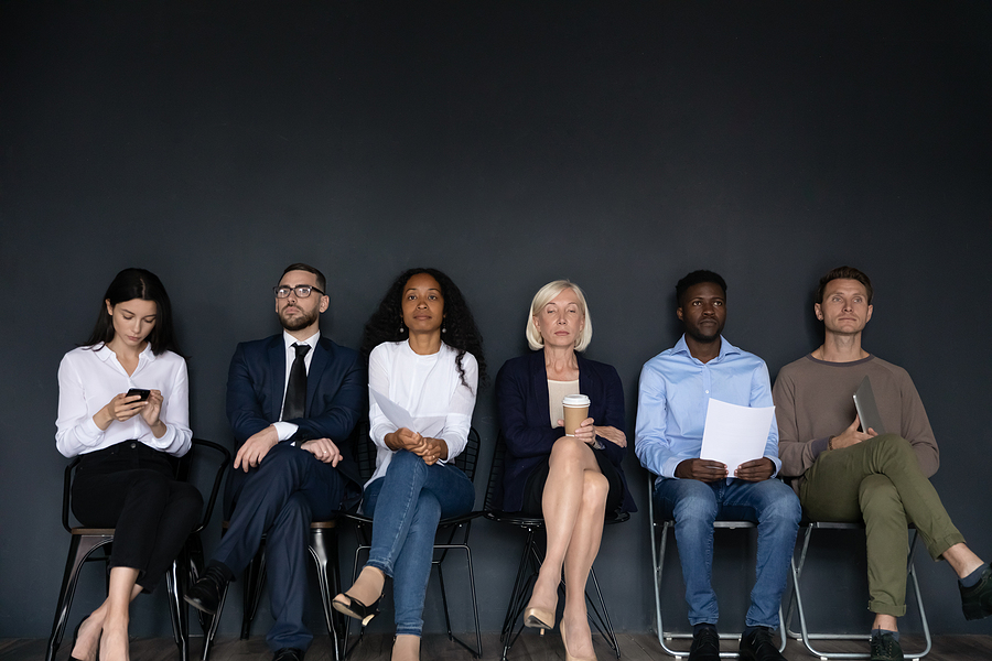 Confident Diverse Business People Sitting On Chairs In Row