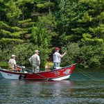 Three men fishing in a boat