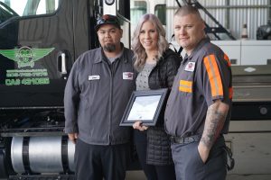 Photo of Mach 1 Towing owner & chamber president with Business of the Month award for February 2020