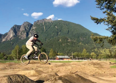 northbend-torguson biker on bike trail with mountains in background