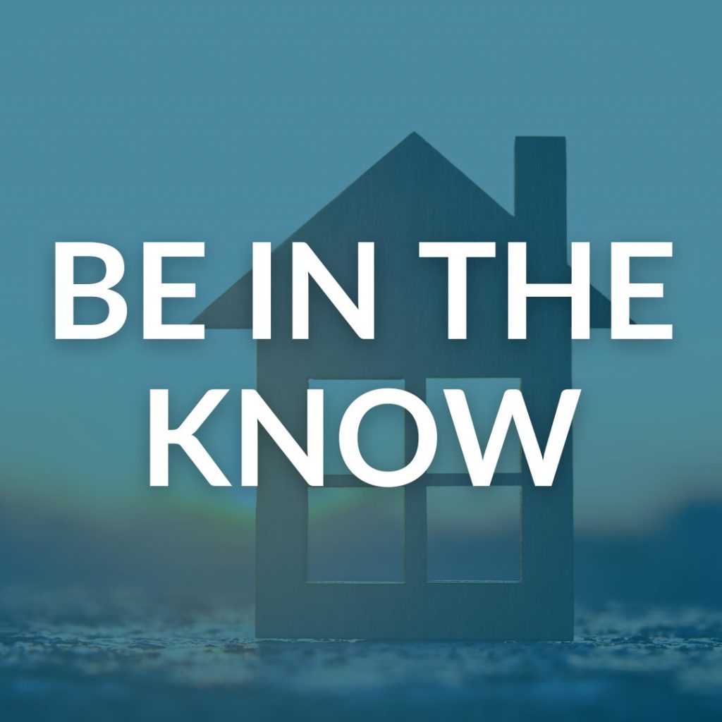 Be in the know in front of a cut-out of a house and sunrise