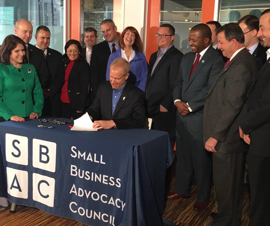 The SBAC team and Governor Bruce Rauner while he sign the LLC Fee Reduction bill