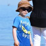 Little boy holding his sand bucket by lake erie