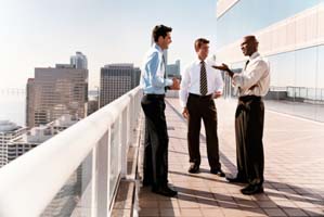 dv1925007 Group of Businessmen Standing on a Balcony, Talking and Laughing