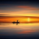 Man fishing at sunset