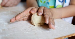 Teen baking lesson with ball of dough