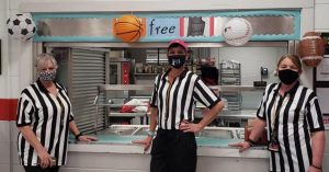 Rachelle Wuellner and two other nutrition workers are dressed up as referees for child nutrition engagement