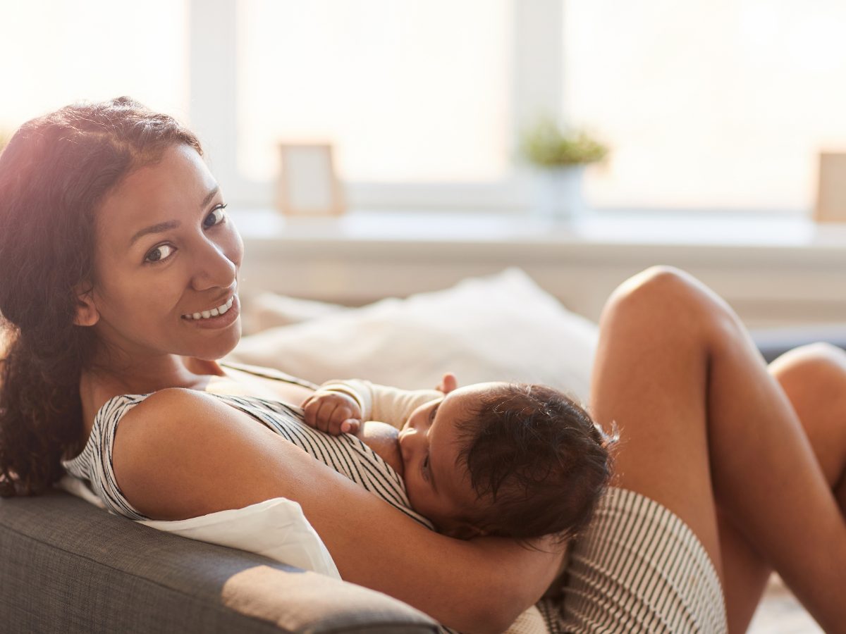 A southeast Asian woman breastfeeds an infant