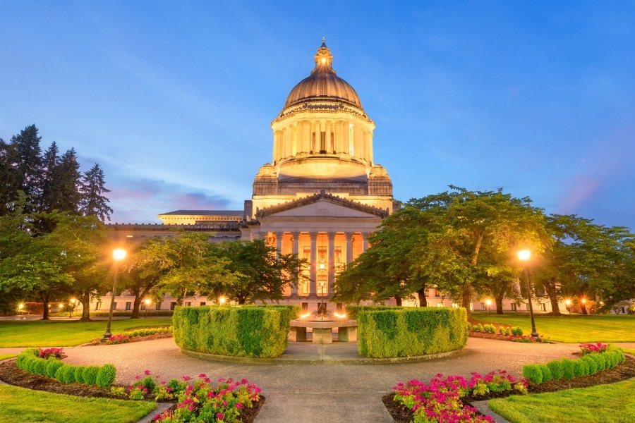 View of Olympia Washington's domed capitol building during dusk.