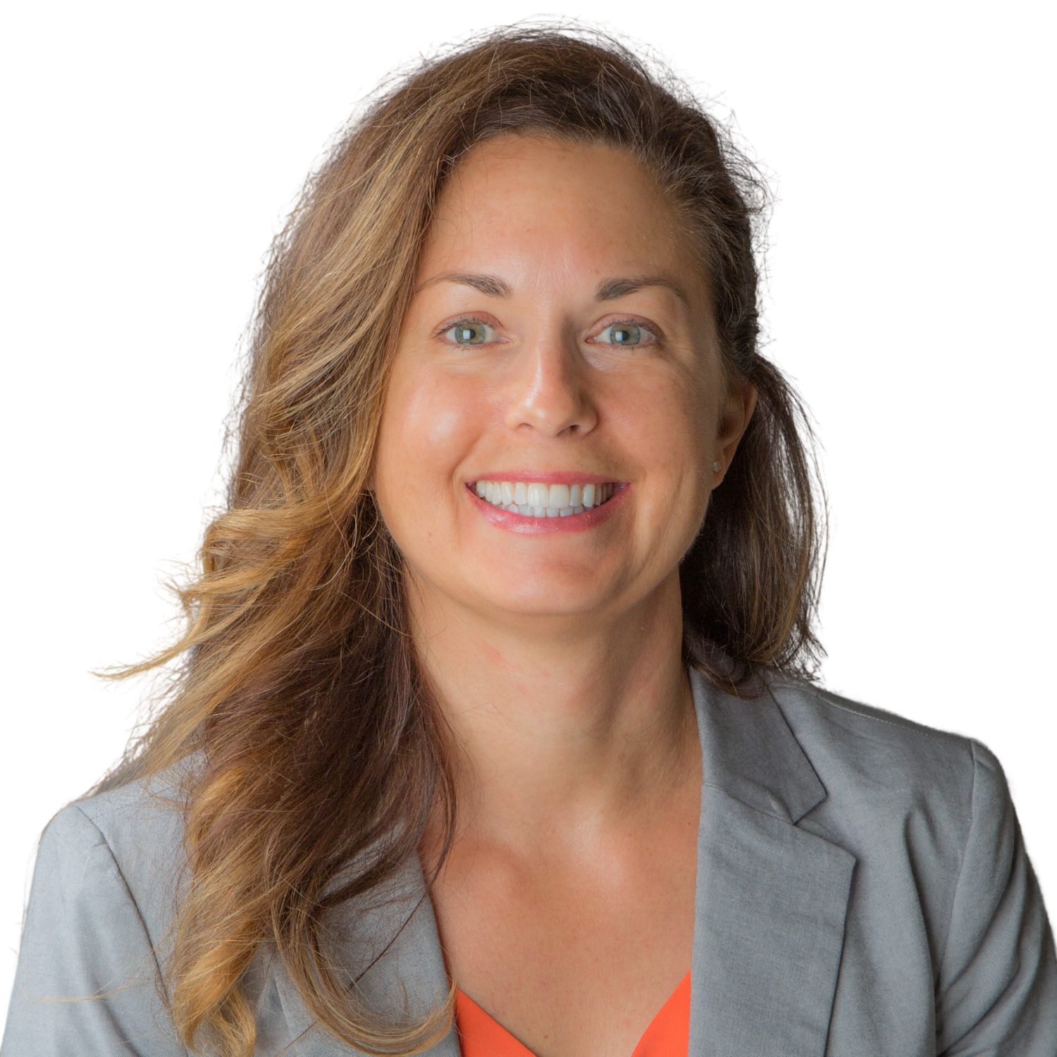White woman with brown hair, orange shirt and gray suit