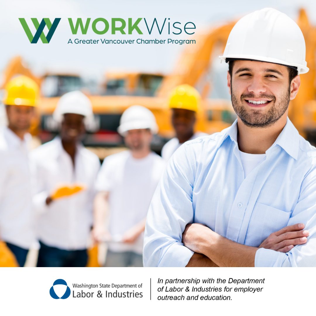 A white man in a hard hat stands smiling with his arms crossed while two black men and two white men with hardhats stand in the background.