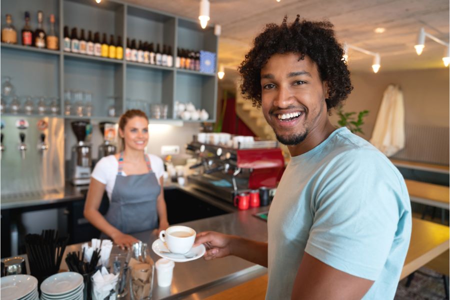 Happy customer and employee at coffee shop.