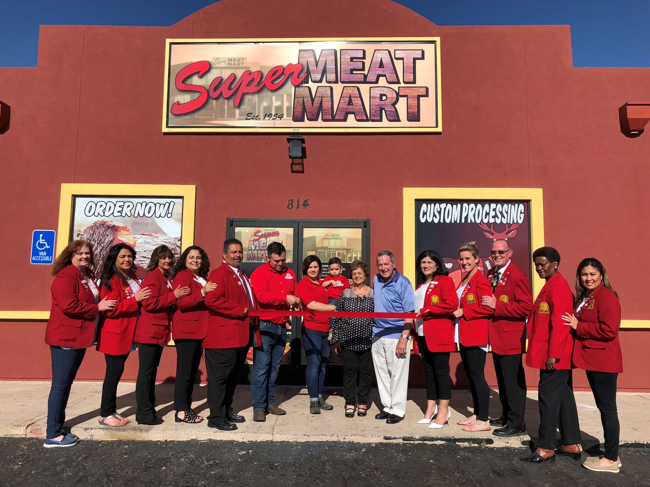 Redcoats attend ribbon cutting event at Super Meat Mart