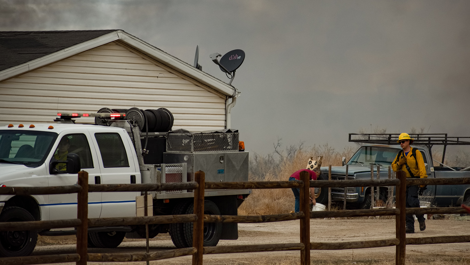 Firefighters protecting home in brushfire