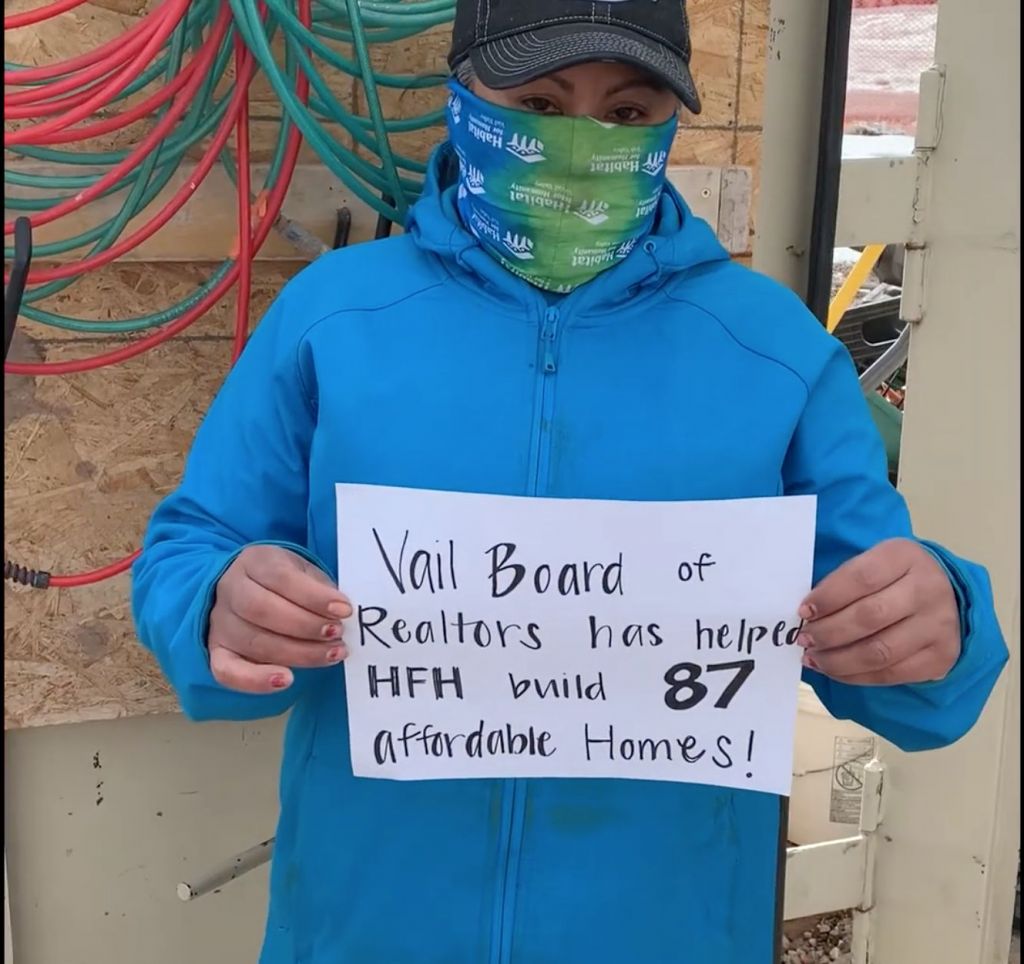 Habitat homeowner with sign thanking the VBRF