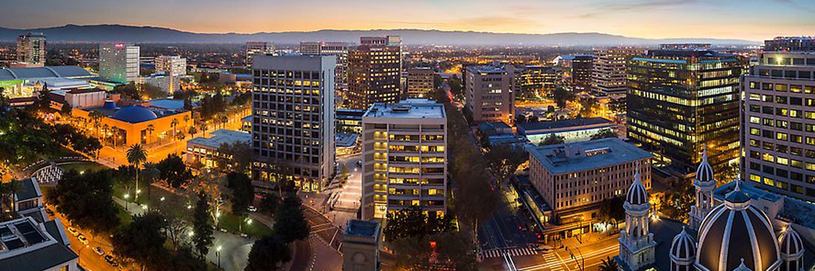 Downtown San Jose skyline and Santa Cruz Mountains at dusk. San Jose, California, USA