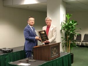 two people with an award